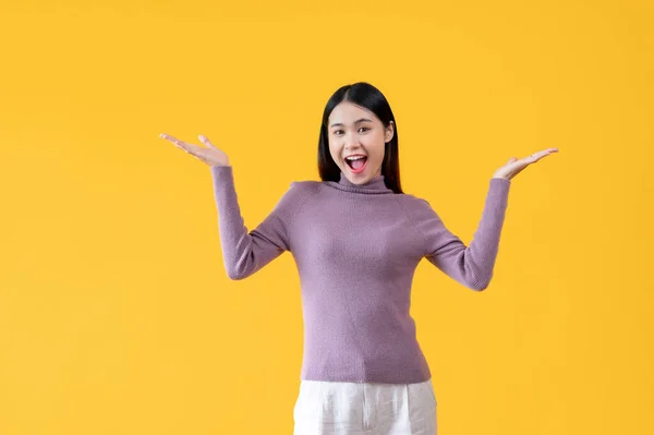 Cheerful Excited Asian Woman Opening Her Palms Standing Isolated Yellow — Stock Photo, Image