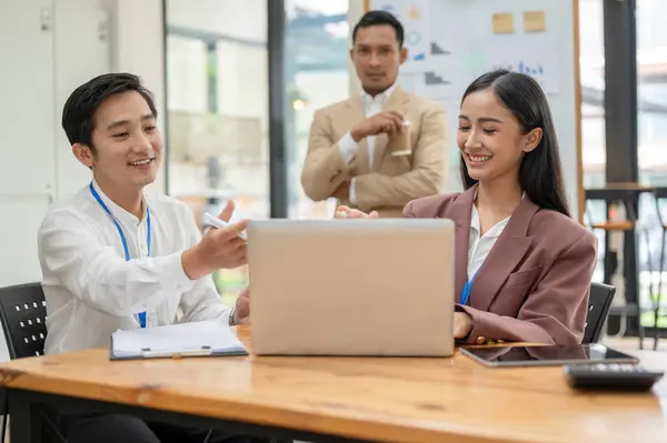 Profesyonel ve mutlu bir Asyalı işadamı, ofisteki yeni bir iş arkadaşı ile iş ve planlar hakkında görüşlerini paylaşıyor..