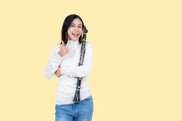 Cheerful Talented Asian Female Musician Clarinet Shows Her Thumb Stands — Stock Photo, Image