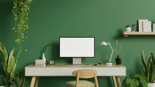 Modern green home office workspace interior design with a computer blank screen mockup on a minimal desk, indoor tropical plants, a chair, a wall shelf, and decor. 3d render, 3d illustration