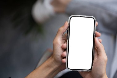 Açık havada akıllı telefonunu kullanan bir adamın yakın plan görüntüsü. Grafik reklamlarınızı göstermek için beyaz ekran akıllı telefon modeli. İnsanlar ve teknoloji kavramları
