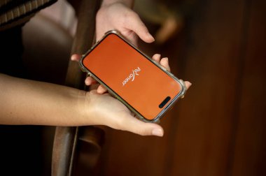 Chiang Mai, Tayland - Nisan 03 2024: iPhone14 ekranındaki Payonez logosu, kapalı alanda otururken Payonez uygulamasını kullanan bir kadın.