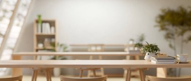 Bir kütüphanedeki minimalist çağdaş okuma odasının ya da çalışma alanının iç tasarımı uzun ahşap masalar, tabureler, bir kitaplık ve dekor içerir. 3d görüntüleme, 3d illüstrasyon