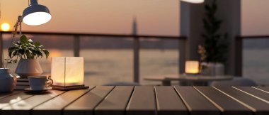 Ürünleri ahşap bir masa üstünde sergilemek için bir kopya alanı, gün batımında bir nehrin bulanık arka planına sahip bir kahve fincanı, masa lambası ve dekor içerir. 3d görüntüleme, 3d illüstrasyon