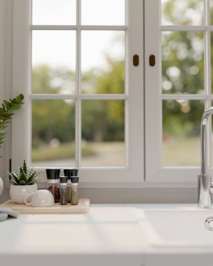 Lavabo, baharat şişeleri, kahve fincanı ve pencereye karşı dekor bitkisi olan beyaz ve temiz bir mutfak tezgahının yakın çekimi. 3d görüntüleme, 3d illüstrasyon