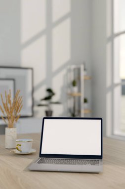 Beyaz ekran maketi olan bir dizüstü bilgisayarın yakın plan görüntüsü, otlu seramik bir vazo, ve minimalist beyaz bir odada ahşap bir masada bir kahve fincanı. 3d görüntüleme, 3d illüstrasyon