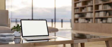 Beyaz ekran maketi, dekor bitkisi ve çağdaş oturma odasındaki modern bir sehpanın üzerindeki kitaplarla bir dizüstü bilgisayarın yakın çekim görüntüsü. 3d görüntüleme, 3d illüstrasyon
