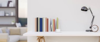 Kitapların, kahve fincanının, alarmın ve masa lambasının olduğu bir odanın beyaz duvarına dayalı beyaz bir masa resmi. ev çalışma alanı, 3d görüntüleme, 3d illüstrasyon