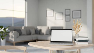 Beyaz ekran maketi, kitapları ve vazodaki çimleri olan bir dizüstü bilgisayar, çağdaş bir oturma odasındaki ahşap bir masanın üzerindedir. ev çalışma alanı, iş yeri, 3D çizim, 3D illüstrasyon