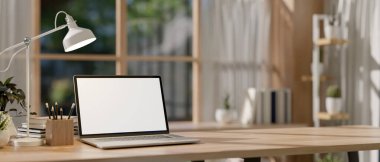 Parlak minimalist bir odadaki ahşap bir masada boş ekran maketi ve kırtasiyesi olan bir dizüstü bilgisayar. Çalışma alanı, çalışma yeri, 3D çizim, 3D illüstrasyon