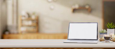 Minimalist bir kahve dükkanının masasında beyaz ekran maketi ve dekoratif eşyaları olan bir dizüstü bilgisayarın yakın çekimi. 3d görüntüleme, 3d illüstrasyon