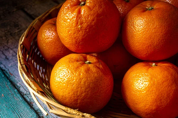 View of sweet oranges in a basket. Kinnow oranges on wooden basket.