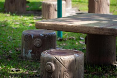 A wooden table in a picnic spot for recreational activities. Picnic table for resting and eating in outdoor park