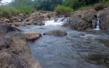 Tranquil Waters of the Muthirapuzha River Winding Through the Scenic Hills of Munnar, Kerala clipart