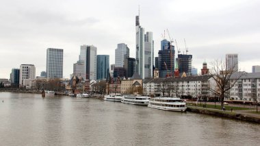 View downstream of the river Main, with skyline of modern skyscrapers of the right bank of the river, Frankfurt, Germany - January 22, 2023