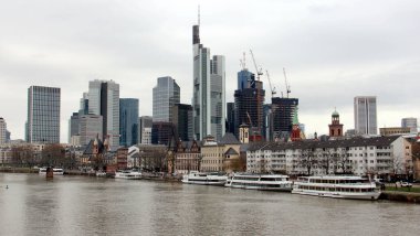 View downstream of the river Main, with skyline of modern skyscrapers of the right bank of the river, Frankfurt, Germany - January 22, 2023