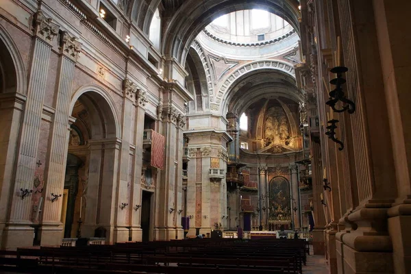 stock image Interior of the Basilica, view of the central nave toward the altar, 18th cen. Baroque and Neoclassical styles, Palace-Convent of Mafra, Portugal - December 22, 2021