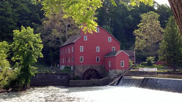 Red Mill, industrial water mill built c.1810, on the South Branch Raritan River, Clinton, NJ, USA - May 25, 2019