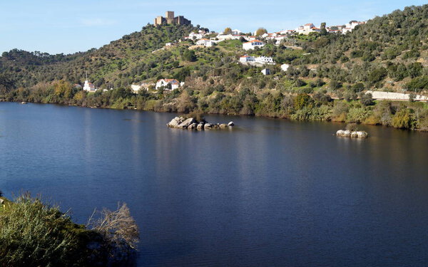 Tagus River, with the hilltop medieval Castle of Belver, on the right bank, overlooking the landscape, Belver, Portugal - November 25, 2023