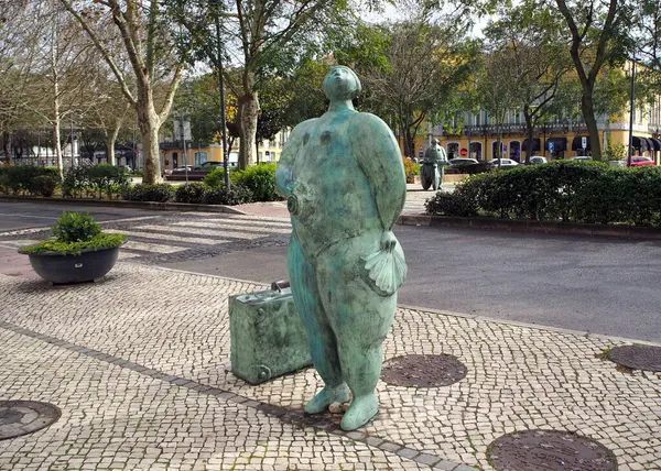 stock image 'Girl with the Suitcase', bronze sculpture by Joao Duarte, installed in 2017 on Avenida Luisa Todi, at the entrance to the old town, Setubal, Portugal - February 27, 2024