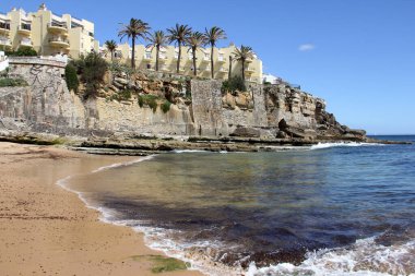 Sahilin kenarındaki sahil kayalıkları, Praia do Azarujinha, Estoril, Portekiz - 18 Mayıs 2024