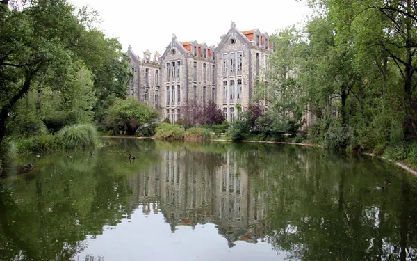 stock image Historic Spa Pavilions, view across the pond in the Dom Carlos I Park, Caldas da Rainha, Portugal - May 17, 2024