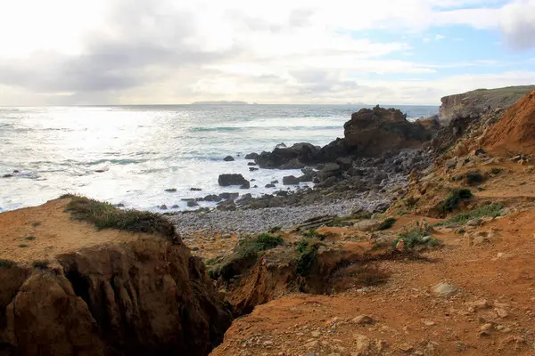 Stock image Coastal rock formations at the beach on western side of Papoa Island, promontory near Peniche, Portugal - May 18, 2024