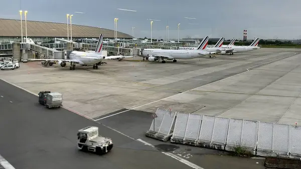 stock image Five AIR FRANCE airliners docked at the boarding bridges of the passenger terminal at Paris Charles de Gaulle Airport, in the early morning, Roissy-en-France, France - July 3, 2024