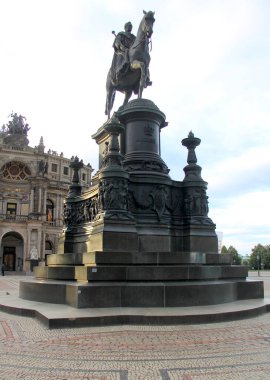 Equestrian statue of King Johann of Saxony at Theaterplatz, front facade of the Semperoper in the background, view at sunset, Dresden, Germany - July 6, 2024 clipart