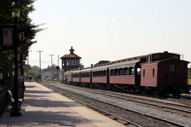 Passenger platform, tracks and old-fashioned excursion train of Strasburg Rail Road, Strasburg, PA, USA - September 7, 2015