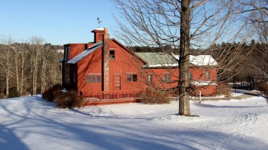 Norman Rockwell Museum, the studio of the artist, winter view with snow-covered lawn in the foreground, Stockbridge, MA, USA - February 14, 2016 clipart