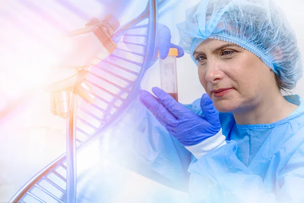 research and developement concept background of DNA strand overlay with blurred female scientist holding tube of blood sample in biotechnology laboratory. concept of gene and chromosome research
