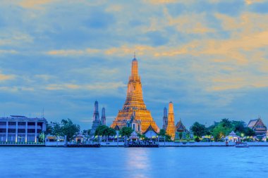 landscape scenery of wat arun pagoda on Chao Phraya river bank in Bangkok Thailand clipart