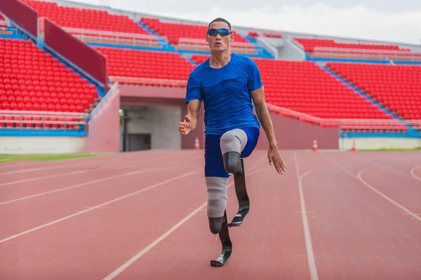 stock image Asian male athlete with prosthetics runs at full speed, demonstrating a powerful practice on stadium track