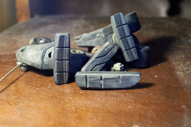 Photo of used bike brake pads on the table clipart