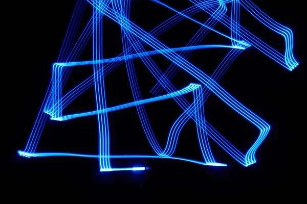 闇の中の青い線の混沌としたパターン — ストック写真