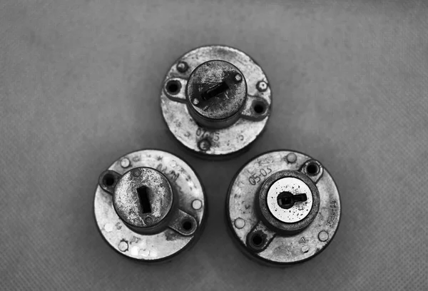 Set of three motorcycle ignition locks black and white photo