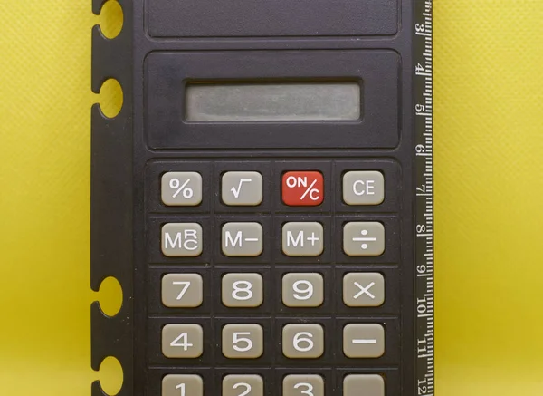 Non-working calculator on a yellow background