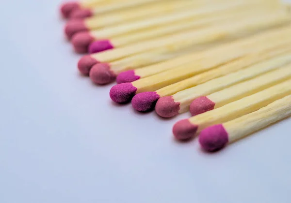 Photo of red matches on white background, selective focus