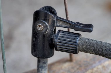 Pump tip on bicycle wheel nipple close up