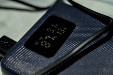 Black powerbank with lcd display showing remaining battery percentage