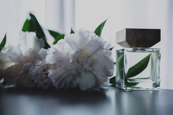 Ένα Μπουκάλι Άρωμα Και Λευκά Λουλούδια — Φωτογραφία Αρχείου
