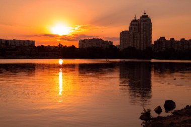 Gölün yakınındaki şehirde altın gün batımı