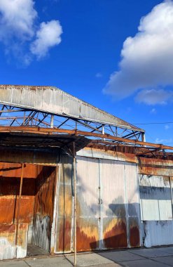 warehouse with a loading ramp after a fire. Burnt metal frame of the building clipart