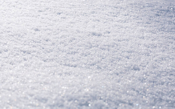 Natural snow texture. The surface of the snow crust. Snowy ground. 