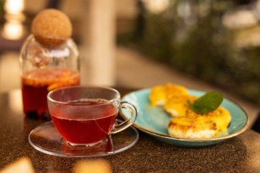 Kahvaltıda meyveli çay ve peynirli kek.