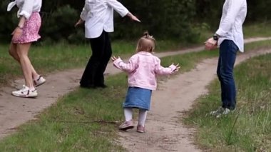 Küçük çocuklu mutlu bir aile parkta eğleniyor.