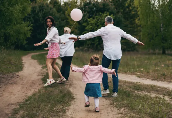 Mutlu aile parkta oynuyor.