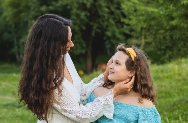 Anne ve kızı doğanın arka planına karşı.