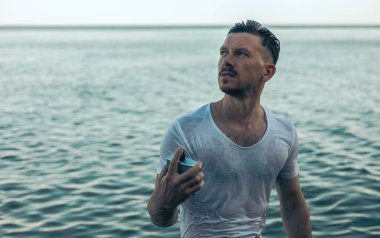 Yakışıklı bir adam ve okyanusa karşı parfüm